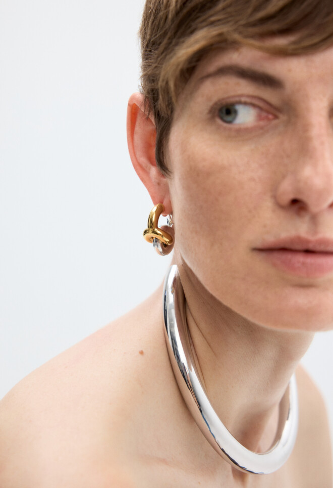Woman wearing Uncommon Matters Mini Creole Earrings in gold and silver bicolor and silver Aurum Collar