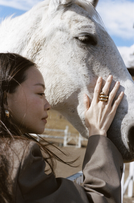 Woman and horse with gold ring photo by Hubert Yang